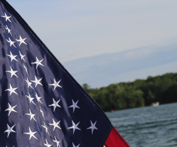American Flag over water
