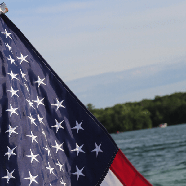 American Flag over water