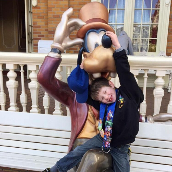 Trentin climbing on Goofy at Disney