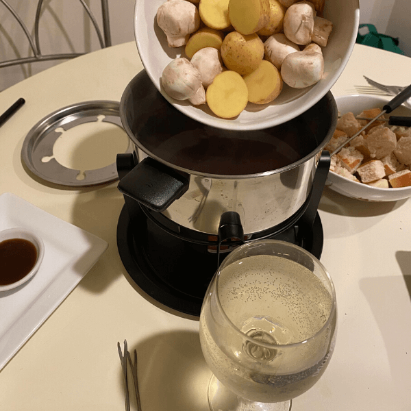 Potatoes and mushroom going into a fondue pot