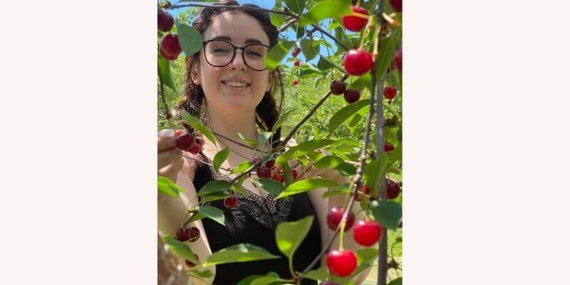 Felicia picking Cherries