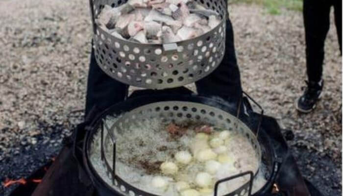 Potatoes and fish going into a fish boil