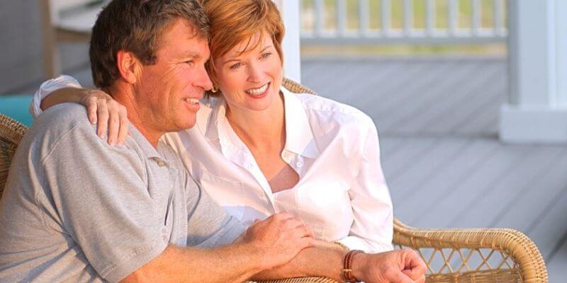 a couple sitting on a porch swing