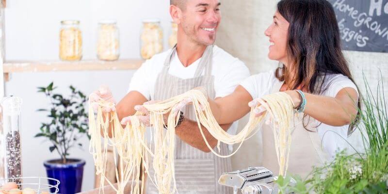 A couple cooking together on a winter staycation