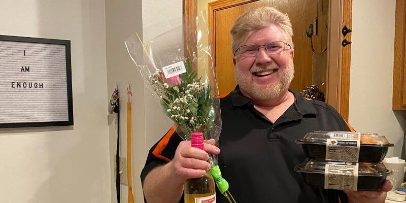 Gary with flowers and kwik trip take home meals