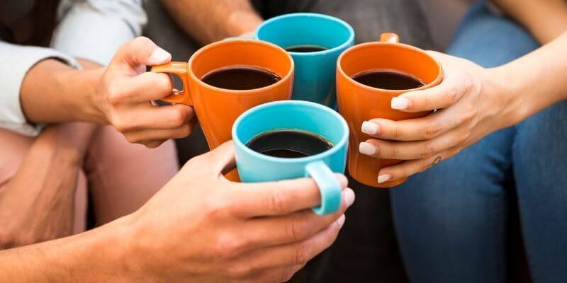 four people drinking coffee