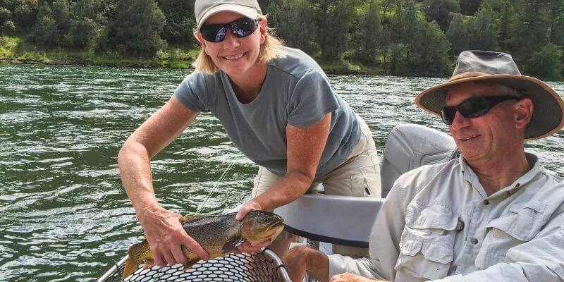 A couple fishing in a boat