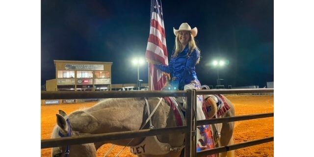 River Ranch Rodeo girl on a horse with an American Flag