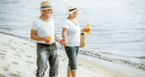 a couple walking on the beach holding hands