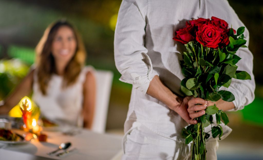 Romantic hotel ideas a man giving a woman flowers